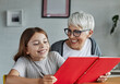 © Lumos sp - grandchild family child grandparent grandmother book reading elderly granddaughter girl  happy together read learning education woman
