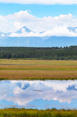 Wall Mural - beautiful landscape of foothill valley in early autumn. on rocky mountains there are low cumulus clo