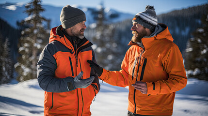 Poster - two men in winter with orange jackets outside with a lot of snow