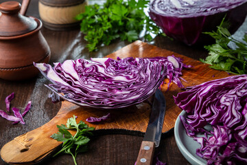 Chopped red cabbage close-up on a cutting wooden board in the kitchen