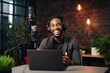 © Jasmina - Young African American man host in headphones enjoying podcasting in his home studio. Handsome podcaster laughing while streaming live audio podcast