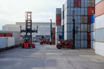 Wall Mural - Forklift trucks handling freight, container boxes in logistic delivery yard with stacks of cargo containers.