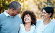 © Anela/peopleimages.com - Love, happy and woman with senior parents in an outdoor park for adventure, holiday or weekend trip. Laugh, smile and young female person hugging with her elderly mom and dad in field from Mexico.