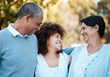 © Anela/peopleimages.com - Happy, smile and woman with senior parents in an outdoor park for adventure, holiday or weekend trip. Love, bonding and young female person in conversation with her elderly mom and dad from Mexico.