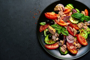 Wall Mural - Tuna salad with cucumber and tomato. Top view with copy space.