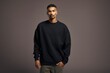 © Tuyres - Isolated Portrait of a Fictional Male Model Wearing a Large Oversized Colored Sweatshirt on a Plain Blank Background. Generative AI.