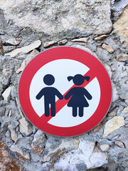 No children allowed sign close up on a stone wall