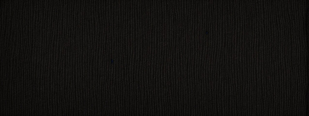 Panoramic close-up texture of natural weave cloth in dark and black color. Fabric texture of natural cotton or linen textile material. Black fabric wide background.