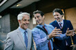 © Marko Geber - Diverse group of businessmen commuting together to work in the city
