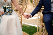 Crop Bride And Groom Holding Hands Outdoors