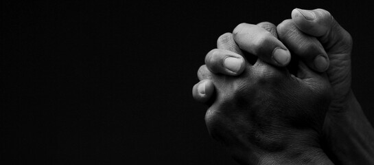Wall Mural - man praying to god with hands together on grey black background stock image stock photo	
