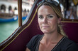 © larrui - Empowered Women Travel Solo: Exploring the Serene Waterways of Venice on a Gondola, ai generative