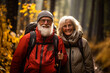 © Valeriia - Romantic and elderly healthy lifestyle concept. Senior cheerful active smiling mature couple hiking with backpacks, look happy in the park in afternoon autumn sunlight day time, happily retired