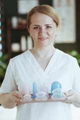 Poster - smiling female medical massage therapist in massage cabinet