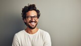 Fototapeta  - Young attractive man with a wonderful smile wearing fashionable spectacles against a neutral background with enough of copy space. generative ai