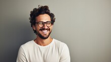 Young Attractive Man With A Wonderful Smile Wearing Fashionable Spectacles Against A Neutral Background With Enough Of Copy Space. Generative Ai