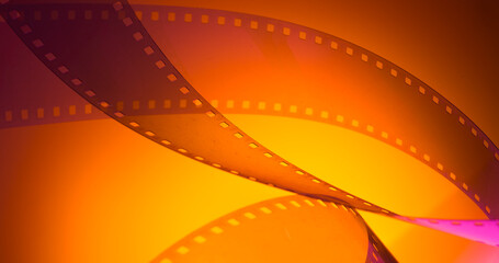 Wall Mural - orange yellow color background with film strip. cinematography premiere film production show industry concept.abstract background with film strip