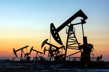 In The Evening, Oil Pumps Are Running, Silhouette Of Beam Pumping Unit