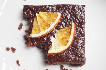 Wall Mural - Chocolate brownies with orange served on a plate, 