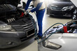 Close-up of a mechanic hand charging a car battery Car repair with jumper cables for transportation