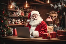 Accounting And Distribution Christmas Gifts For All Children On The Planet. Santa Claus Sits In The Warehouse Of His Factory In Front Of Laptop Monitor.