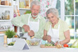 © aletia2011 - senior couple making salad together at kitchen