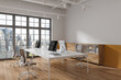 © ImageFlow - Stylish coworking interior with pc monitors and drawer, window. Mockup wall