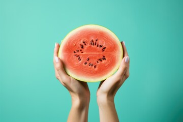 Wall Mural - Female hands with slices of ripe watermelon on green background