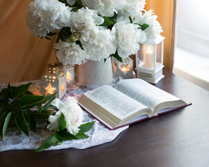 Wall Mural - Still life. Open book and bouquet of flowers