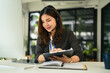 © Prathankarnpap - Beautiful female customer support operator with headset working on support hotline in office