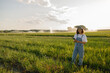 © Kostiantyn - Smiling woman farmer with digital tablet works in field. Agricultural business concept