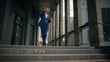 © Yuliia - Old businessman middle-aged Caucasian employee senior business man worker listening to music in headphones holding mobile phone dancing walking down stairs office in city happy good mood success jump