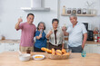 © surachetkhamsuk - Happy Asian senior dining together drinking wine to celebrate