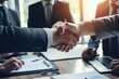 © PHAISITSAWAN - Happy business team shaking hands with clients in the office Smiling executive team making deals with customers and shaking hands at work inside the office conference room.