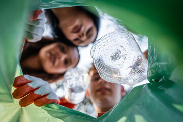 POV from inside of bag young volunteer teenagers collect plastic waste