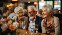 Group Of Senior Friends Having Fun In A Restaurant. They Are Laughing And Drinking Wine.