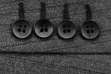 Wall Mural - Close-up of black buttons on the sleeve of a man's jacket. Man's jacket. Button