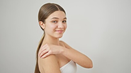 Poster - Young beautiful girl smiling confident touching arm over isolated white background