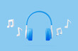 Cartoon headphones and melody note flying on blue background. Concept of listening to music, radio, podcasts and books. Minimal creative concept. 3D render illustration