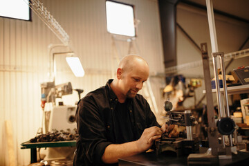 Wall Mural - Middle aged man working in a factory