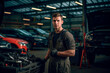 © Mr. Bolota - Skilled Mechanic: Portrait of a German Man Working as a Mechanic in  His Auto Repair Workshop