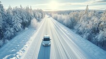 White Car Driving On Winding Road Through Snowy Forest, Sun Light. Concept Winter Travel, Aerial View