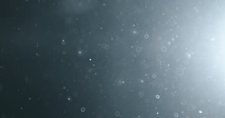 Floating abstract particle bokeh on dark background