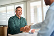 © insta_photos - Smiling middle aged business man handshaking partner making partnership collaboration agreement at office meeting, hr manager and new worker shake hands recruiting at job interview. Welcome onboarding