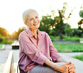 Wall Mural - woman outdoor senior happy retirement elderly portrait female active park smiling old fun nature happiness mature lifestyle beautiful bench