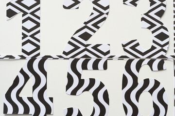 Wall Mural - large numbers machine-cut from black and white card stock and arranged on blank paper (detail)