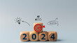 © FAMILY STOCK - 2024 goals of business or life. Wooden cubes with 2024 and goal icon on smart background. Starting to new year. Business common goals for planning new project, annual plan, business target achievement