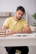 © Elnur - Young male student studying at home