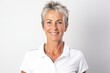 Group portrait photography of a French woman in her 60s wearing a sporty polo shirt against a white background