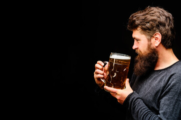 Wall Mural - Beer time. Oktoberfest. Craft beer at restaurant. Bearded man drinking draft beer at pub or bar. Germany tradition. Smiling man with mug of lager beer. Holiday, drink, alcohol and leisure. Copy space.